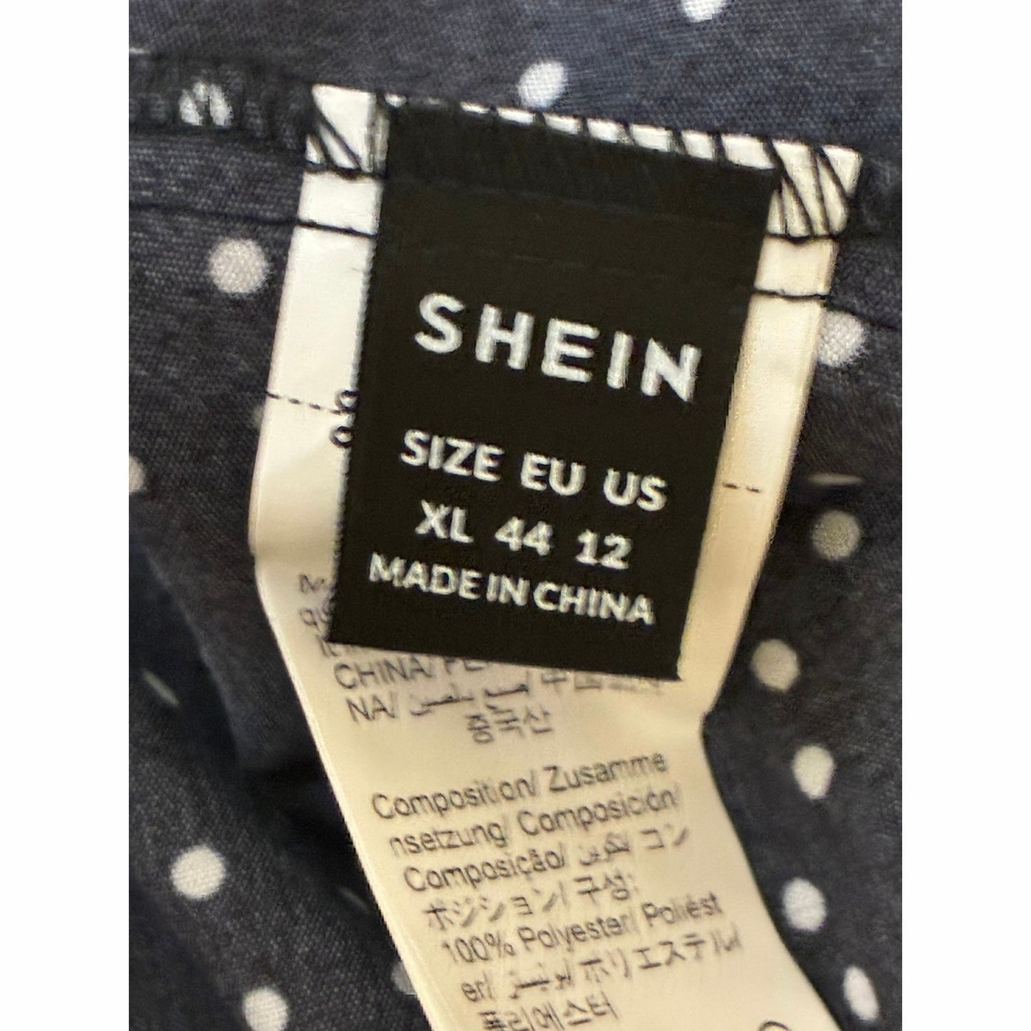SHEIN jumpsuit features a black and white polka dot pattern ruffled tie waist