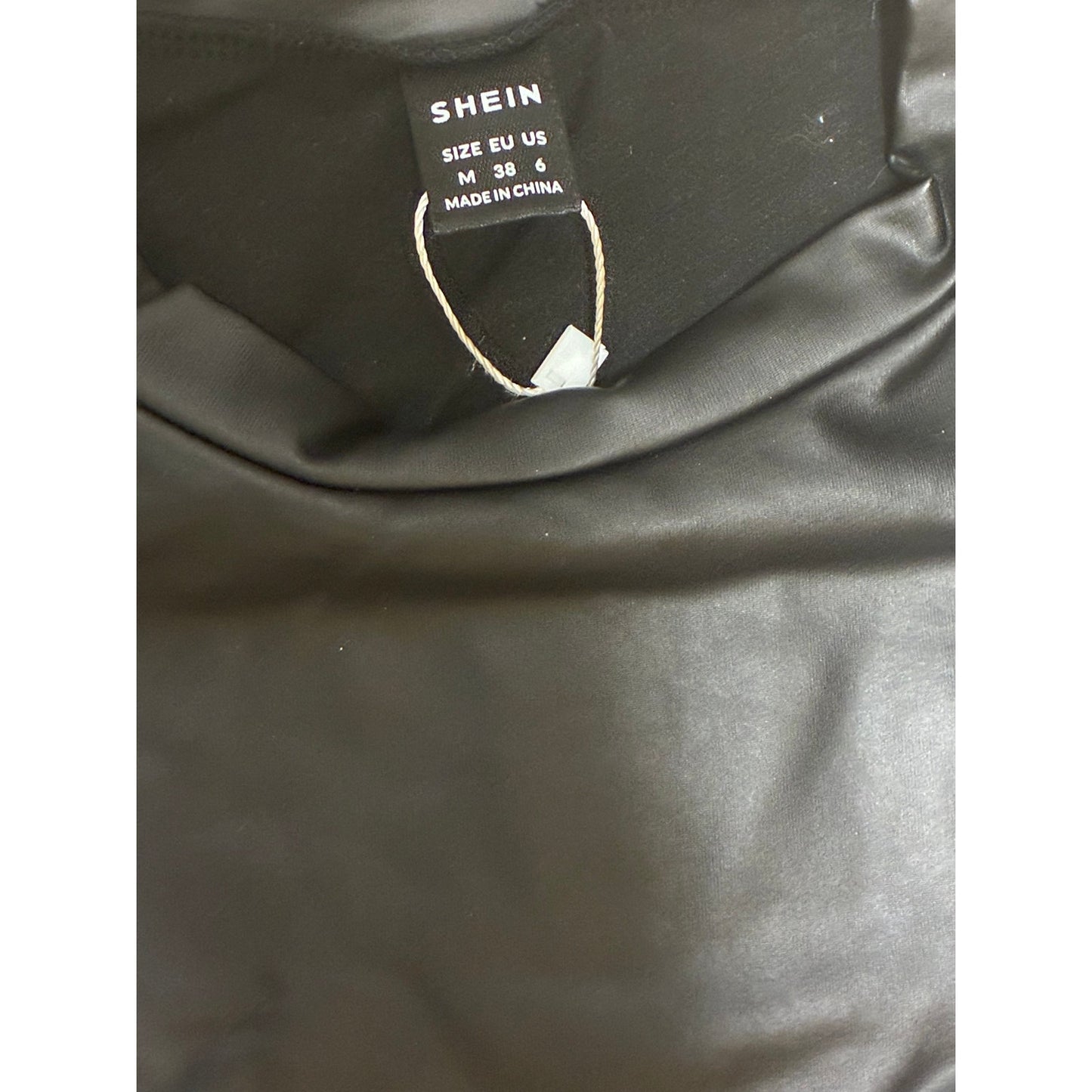 SHEIN black faux leather top features striking puff sleeves
