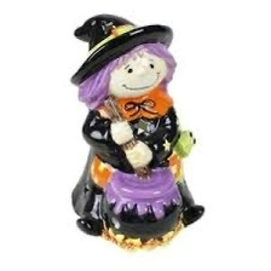 vintage-style ceramic Halloween figurine featuring a witch holding a broom